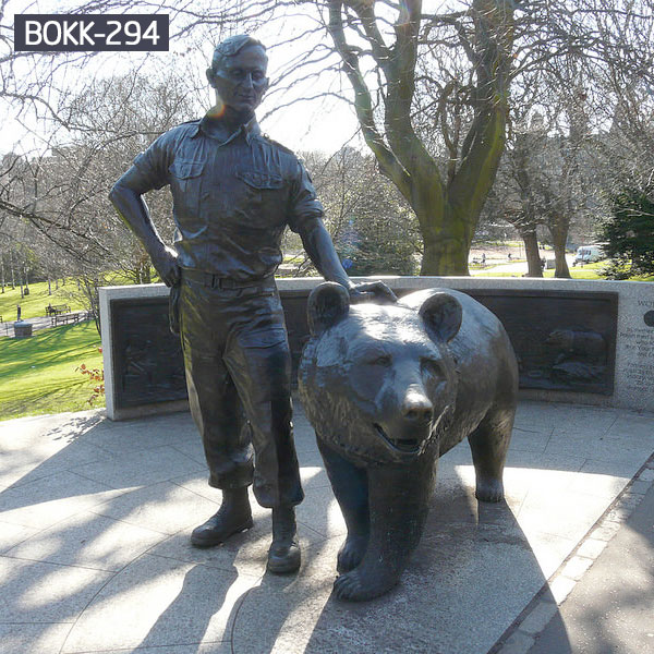 Human and giant grizzly bear statues outdoor garden